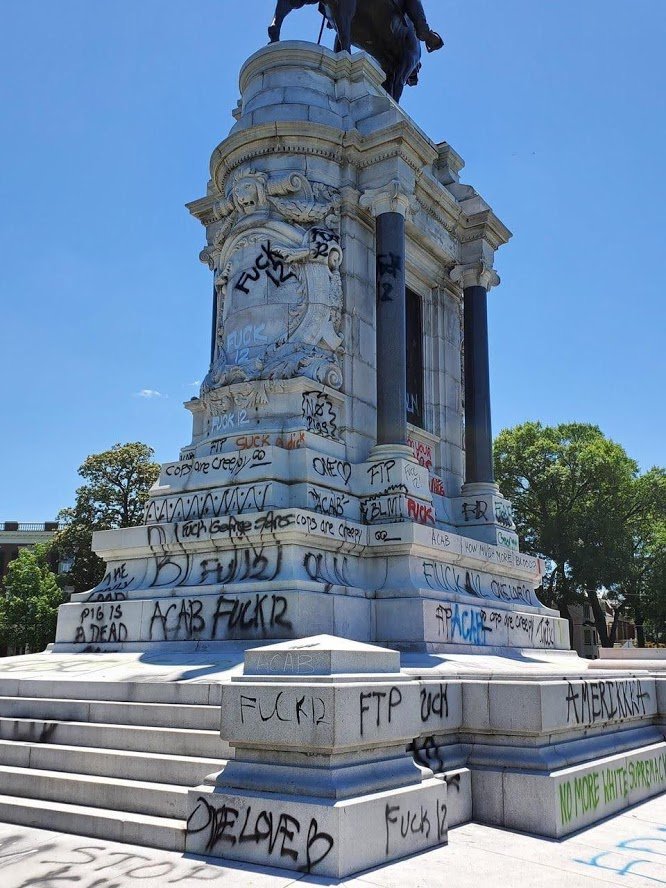 Up close you can read the graffiti on this confederate monument