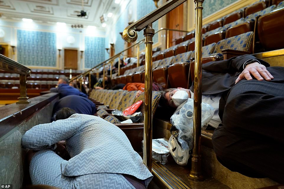 Members of Congress taking cover from the breach of the Capitol building.